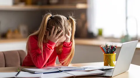 Niña con dificultades para hacer los deberes (Foto: envato)
